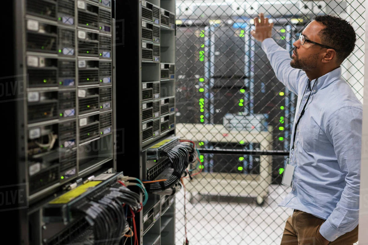 ICT specialist inspecting server infrastructure